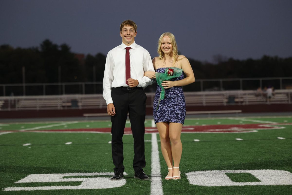 Seniors Emma Hoffman and Will Goodlove smile for their photo before the coronation on Oct. 2. 