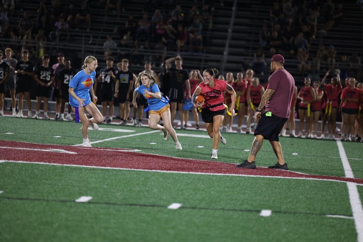Senior Courtney Franck sprints to away from the 50 yard line with the ball Oct. 2. 