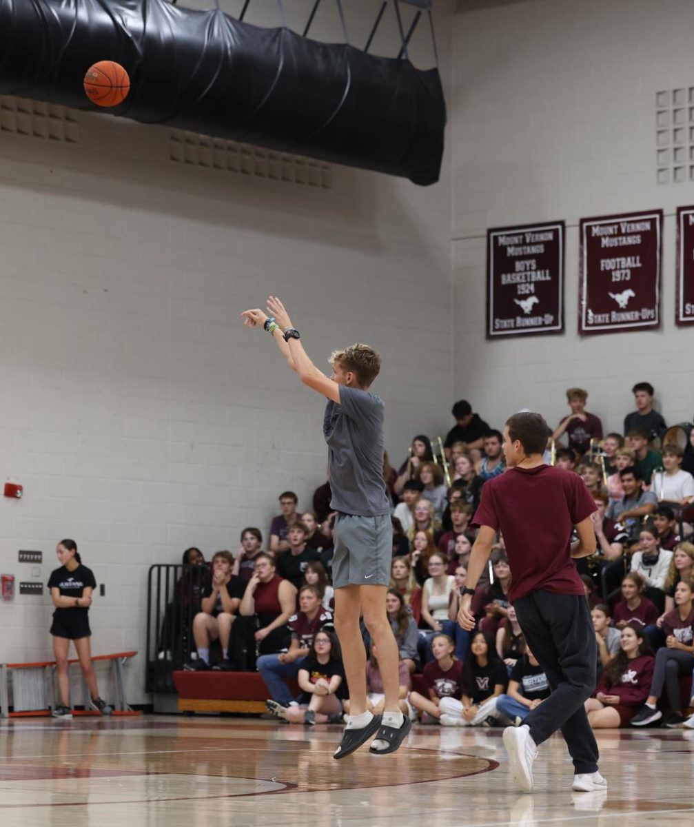 Senior Dawson Scheil tosses a basketball during the 3-3-1 pep rally game on Oct. 3.