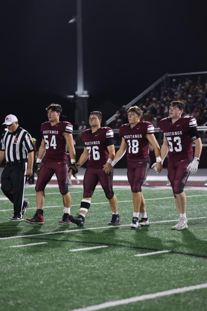 Captains of the football team for this week walk to the midfield to greet the other team. Left to right: Jaxon Anderson (54), Landyn Leyse (76), William Goodlove (18) and Andrew Dix (53).