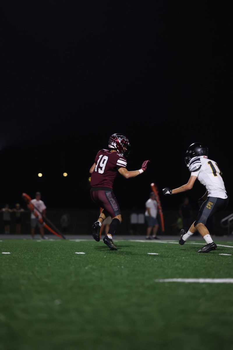 Holden Hlavacek (19) prepares to defend an opponent from Center Point-Urbana on Friday Oct. 3. 