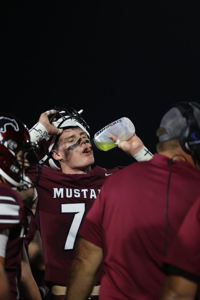 Number 70, Brogan Meyer, refreshes himself with a bottle of Powderade during his game on Friday. 