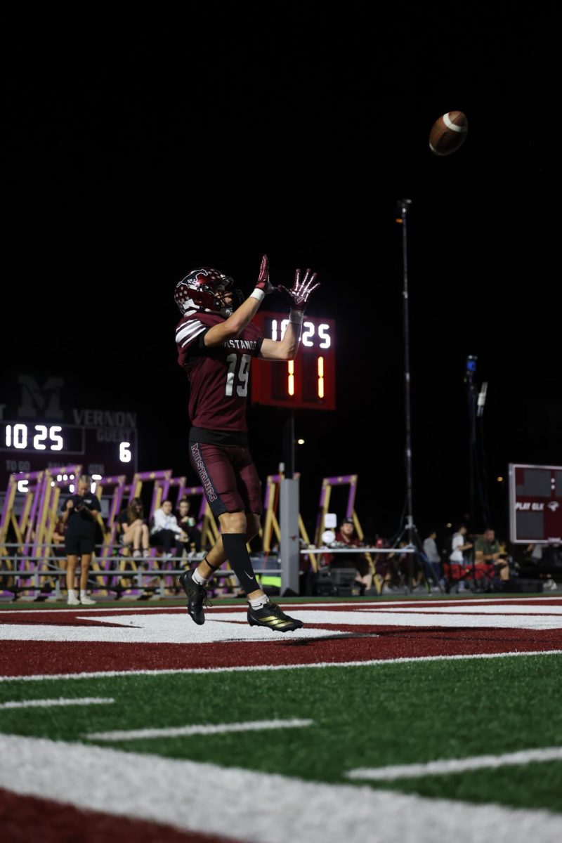 Number 19, Holden Hlavacek, catches a touchdown to increase the Mustangs score against Center Point-Urbana. 