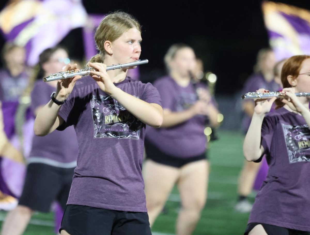 Freshman Josie Hocker plays with the Marching Mustangs during their homecoming halftime show.