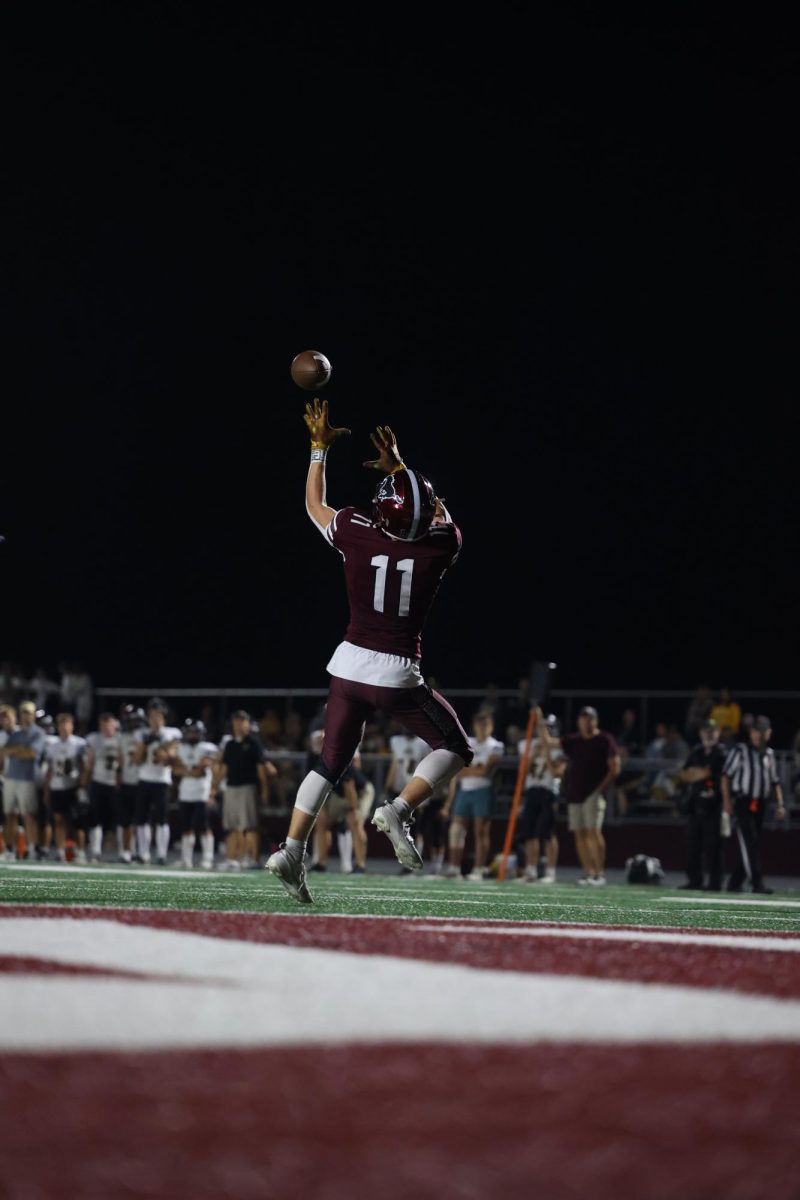 Number 11, Maddox Curran, reaches out to catch a touchdown pass. 