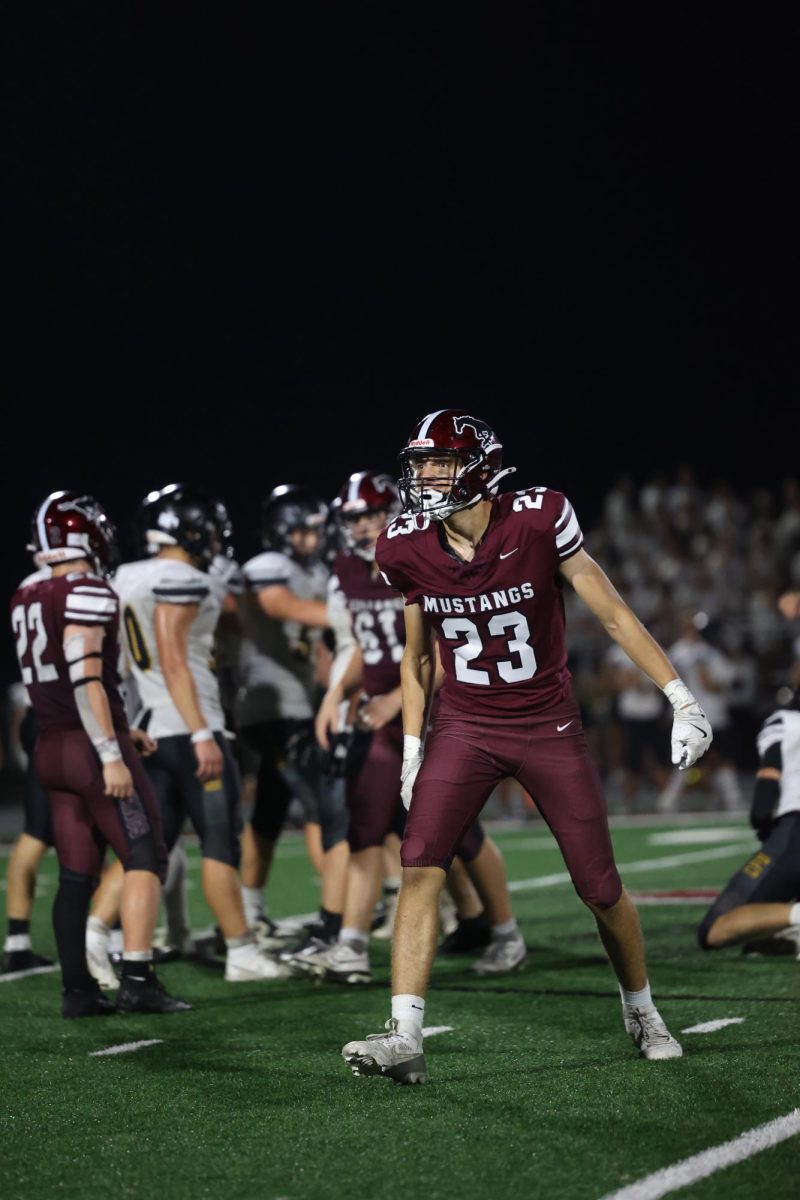 Senior Xander Wegner (24) celebrates his tackle for loss on defense against the Stormin' Pointers. 
