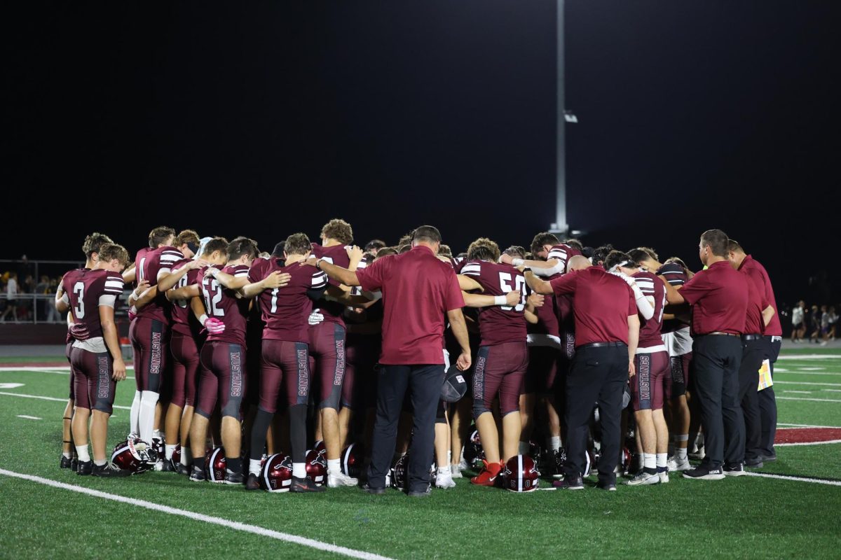 members of the Mount Vernon Football team take a moment together after their game against Center Point Urbana. The Mustangs won their game 34-14.
