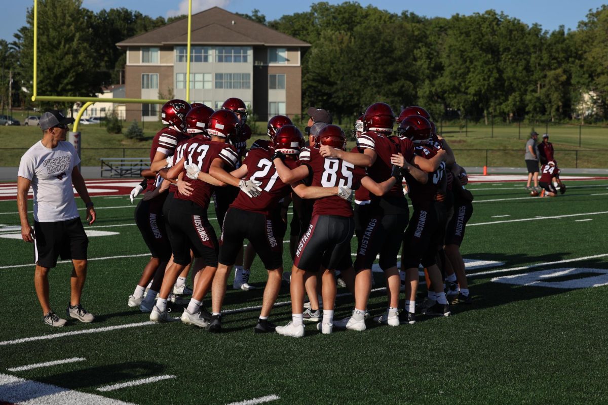 Mount Vernon JV players Huddle up around a coach.