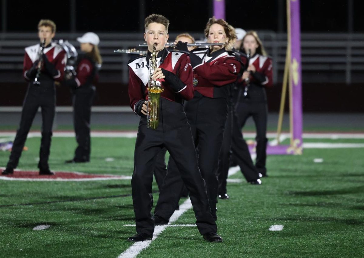 Freshman Jake Martin performs with the Marching Mustangs during their outdoor finale. 