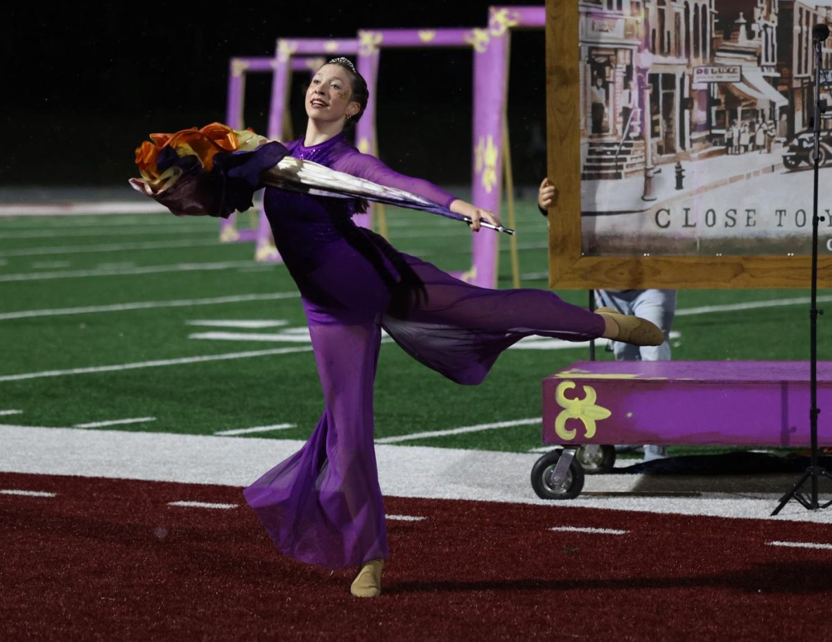 Senior Malena Koehn gracefully finishes her solo during the Marching Mustangs’ performance on Oct. 20.