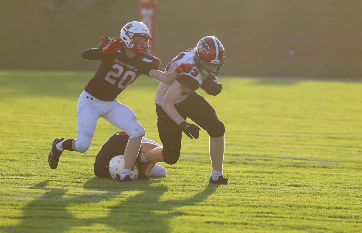 Freshman Mason Bany (33) runs through the Maquoketa defense Sept. 26. The Mustang freshman/ sophomore team won 20-7.