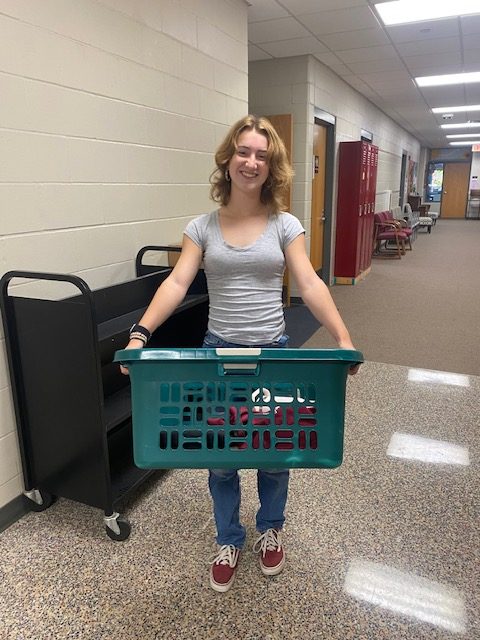 Junior Rose Pisarik poses with her basket for anything but a backpack day on Oct. 3.