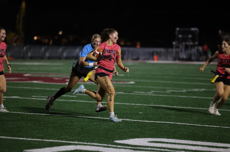 Senior Kaia Swaim runs from Surfer players. 