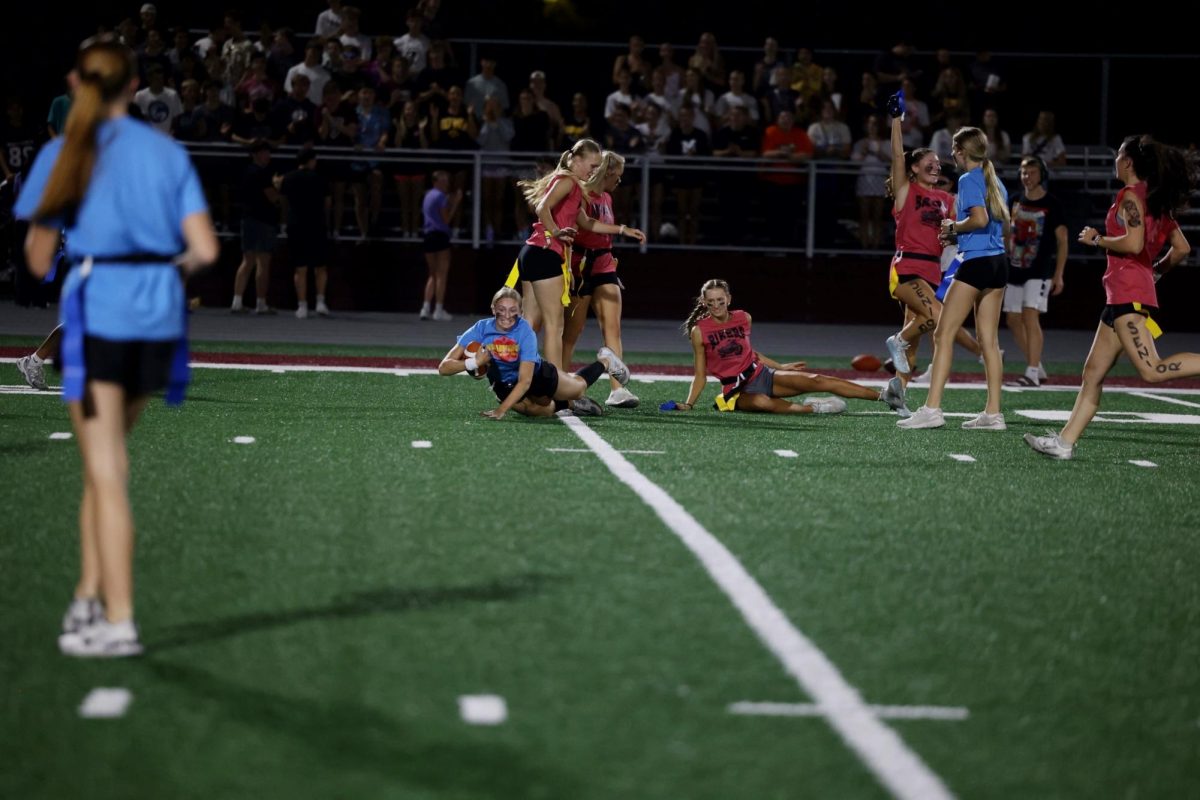 Junior Lucy Wishmeyer hits the ground as senior Kaia Swaim celebrates getting her flag Oct. 2.