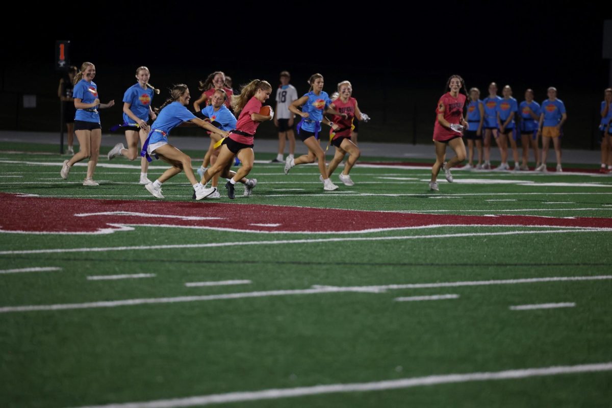 Junior Journey McCartt grabs a flag from senior Taylor Franck as she tries to get to her end zone Oct. 2. 
