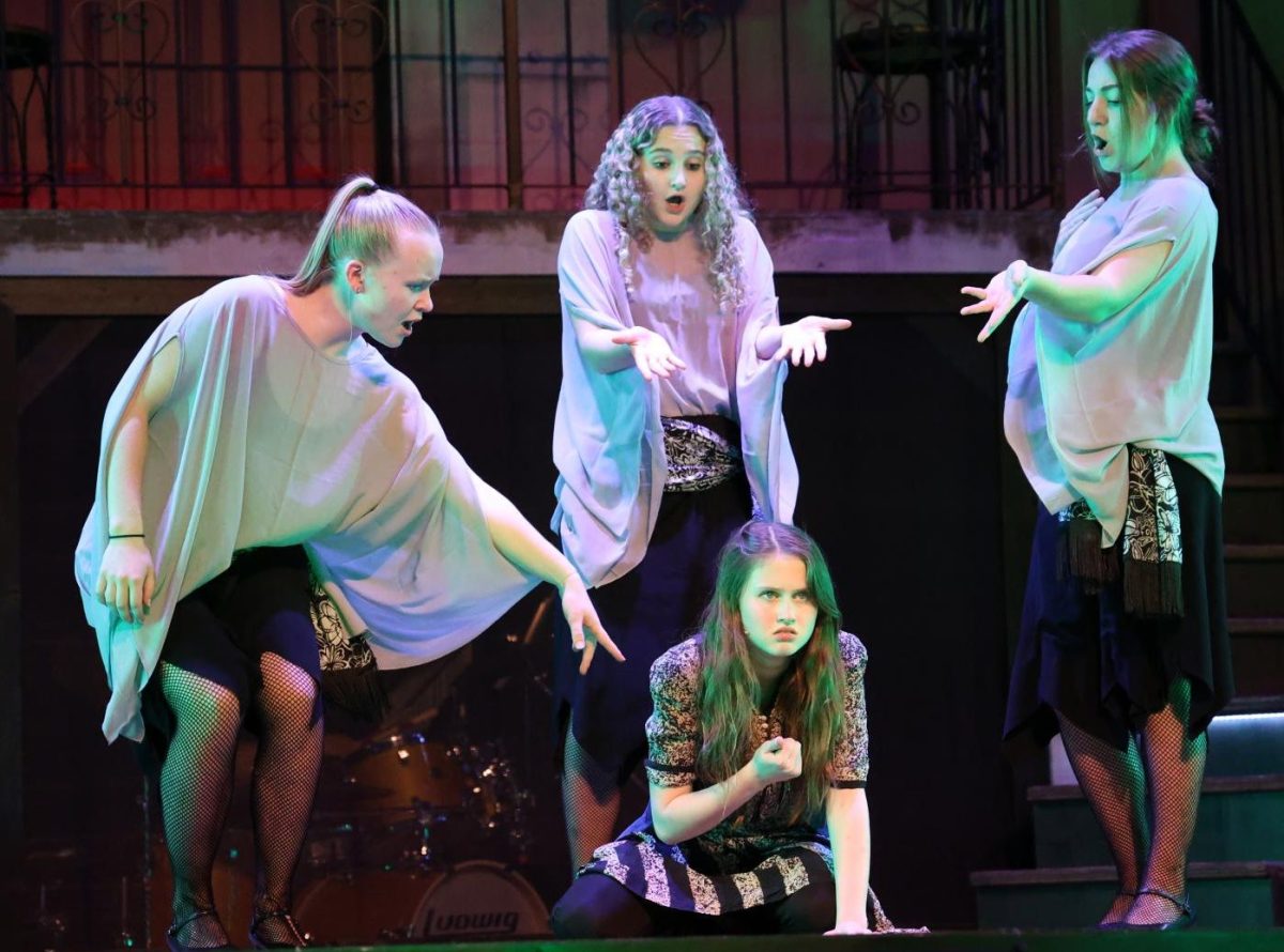 Seniors Emma Hoffman, Grace Bausch, and Addi Whisner, as The Fates, harass Charlotte Woosley (Eurydice) in the song "When the Chips Are Down".