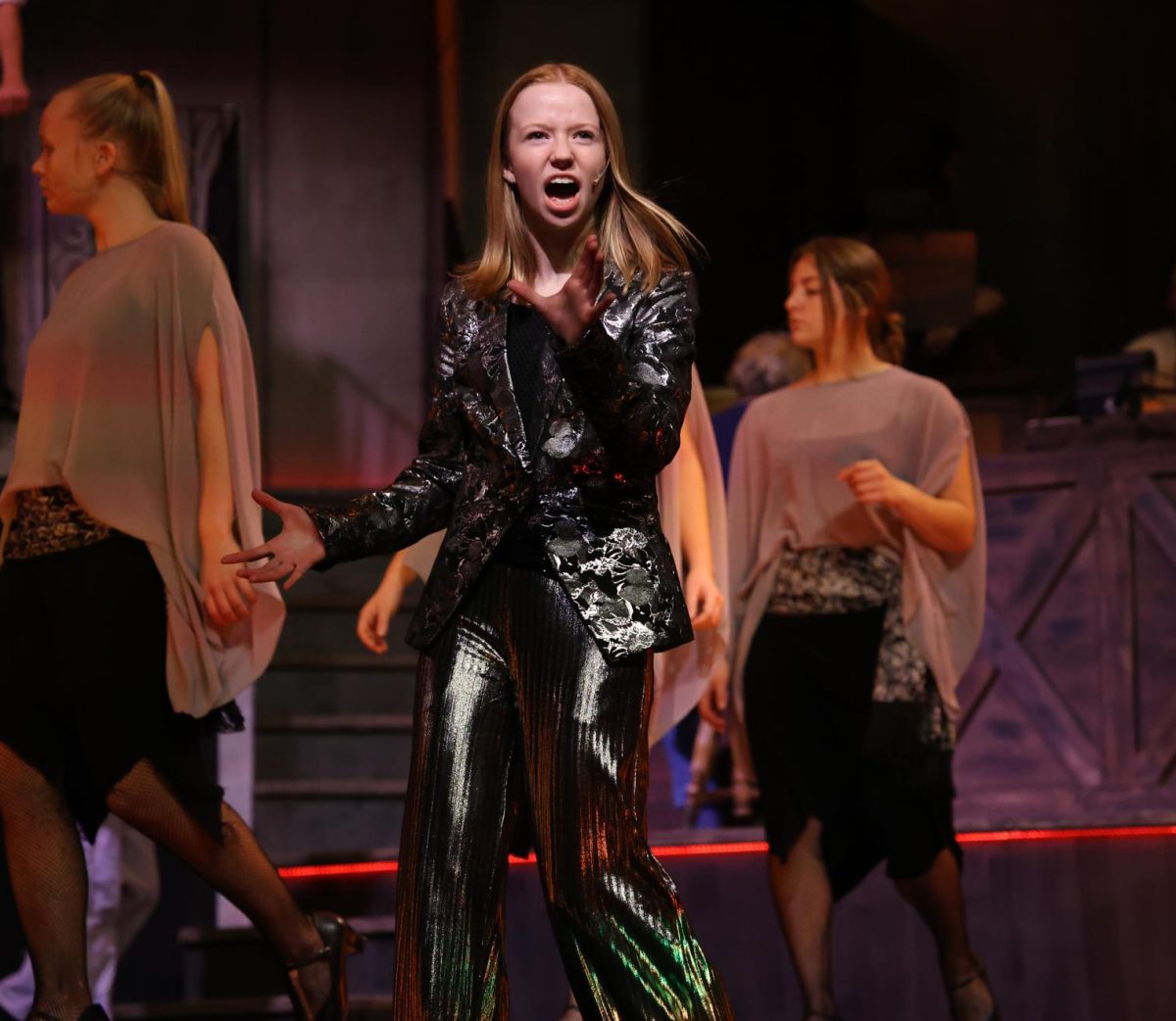 Senior Ingrid Morf (Hermes) gives a warning to Orpheus and Eurydice during "Wait for Me (Reprise)".