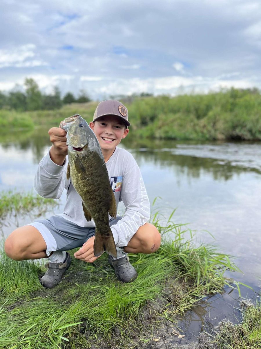 Clay Simpson holding his nIce small mouth he caught in a creek!