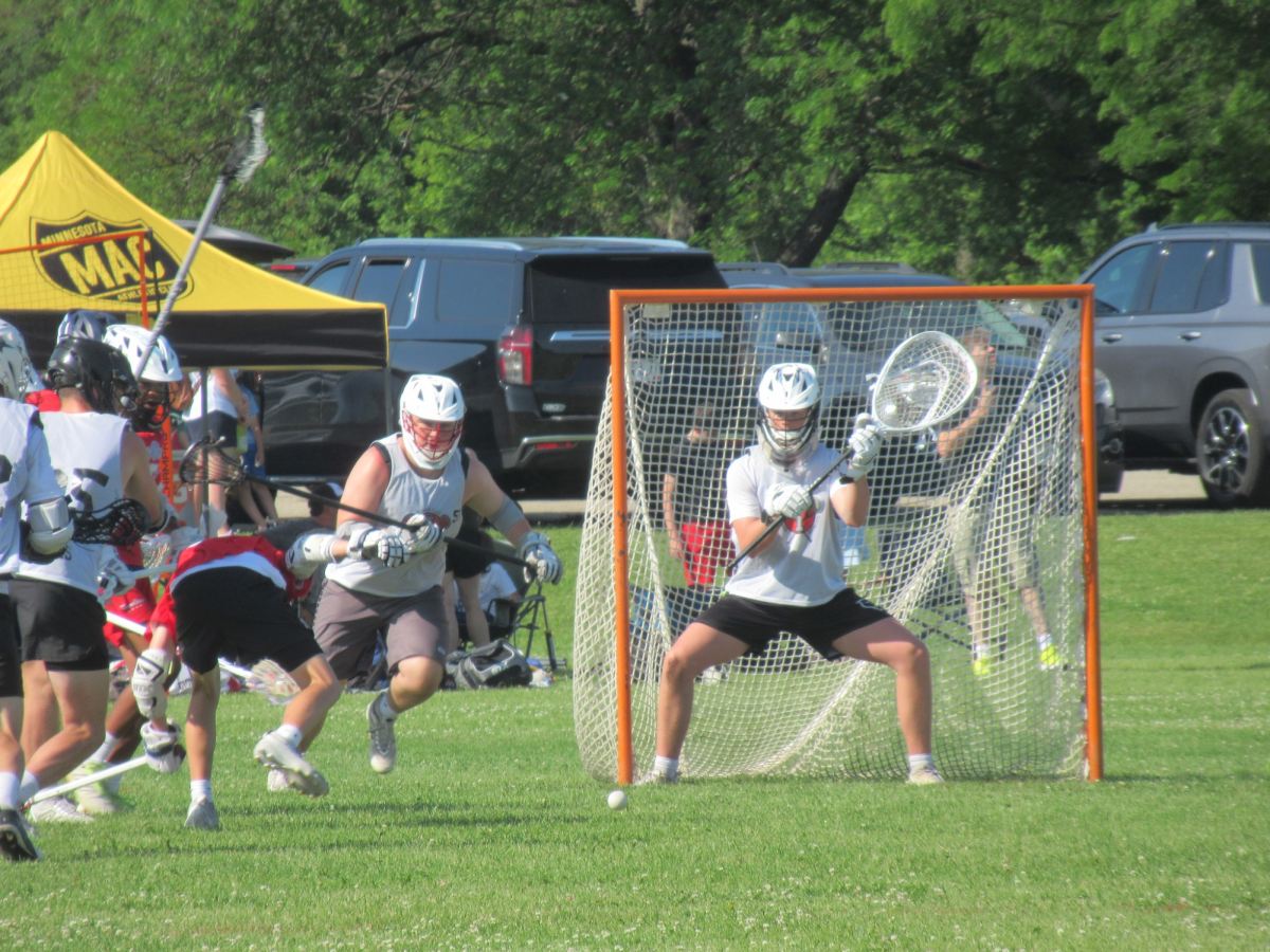 Goalie Andrew Webber preparing to block a shot.