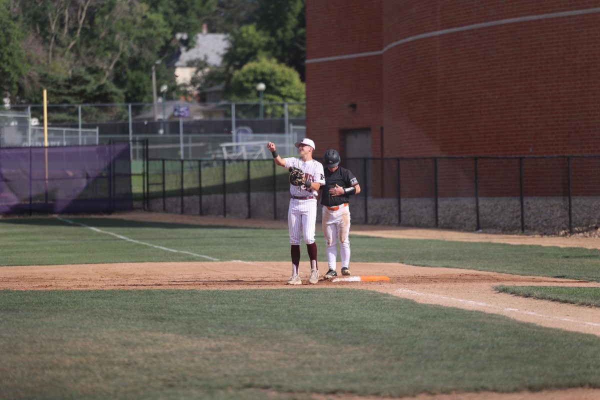 Kellen Haverback throws the ball back to the pitcher against Grinnell June. 2, 2025.