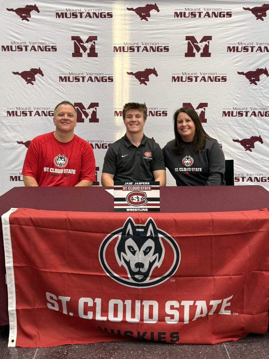 Jase Jaspers poses at his signing ceremony to St. Cloud State wrestling with his parents Dec. 9.