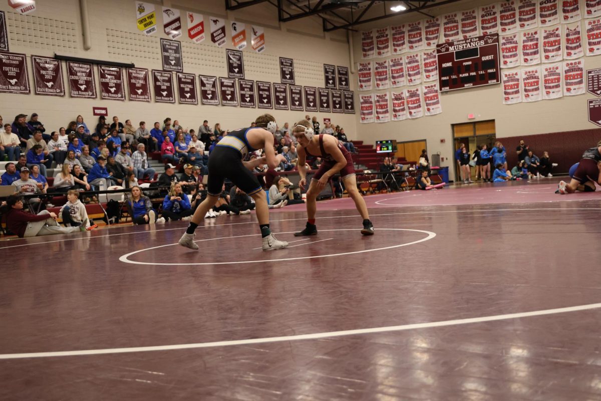 Junior Chasen Caskey wrestles against his opponent from Benton.