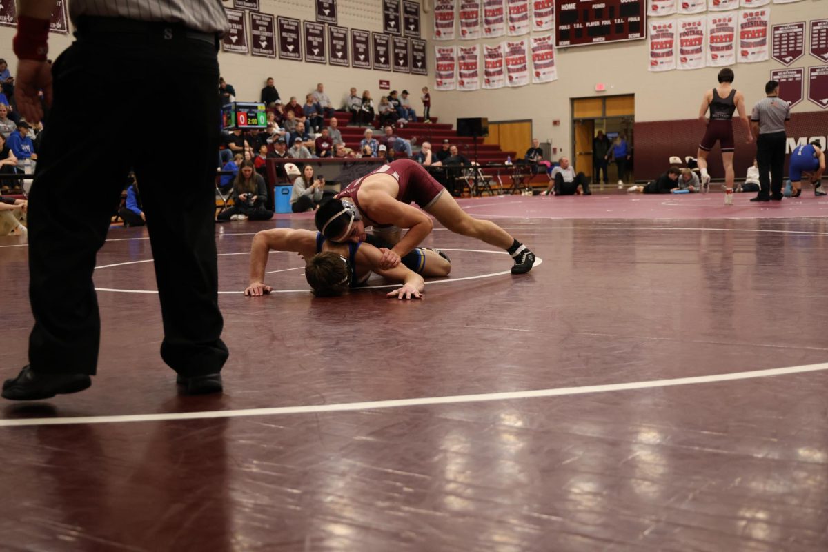 Senior Landon Grosse wrestles Kaden Mitchel from Benton in the 165 weight class.