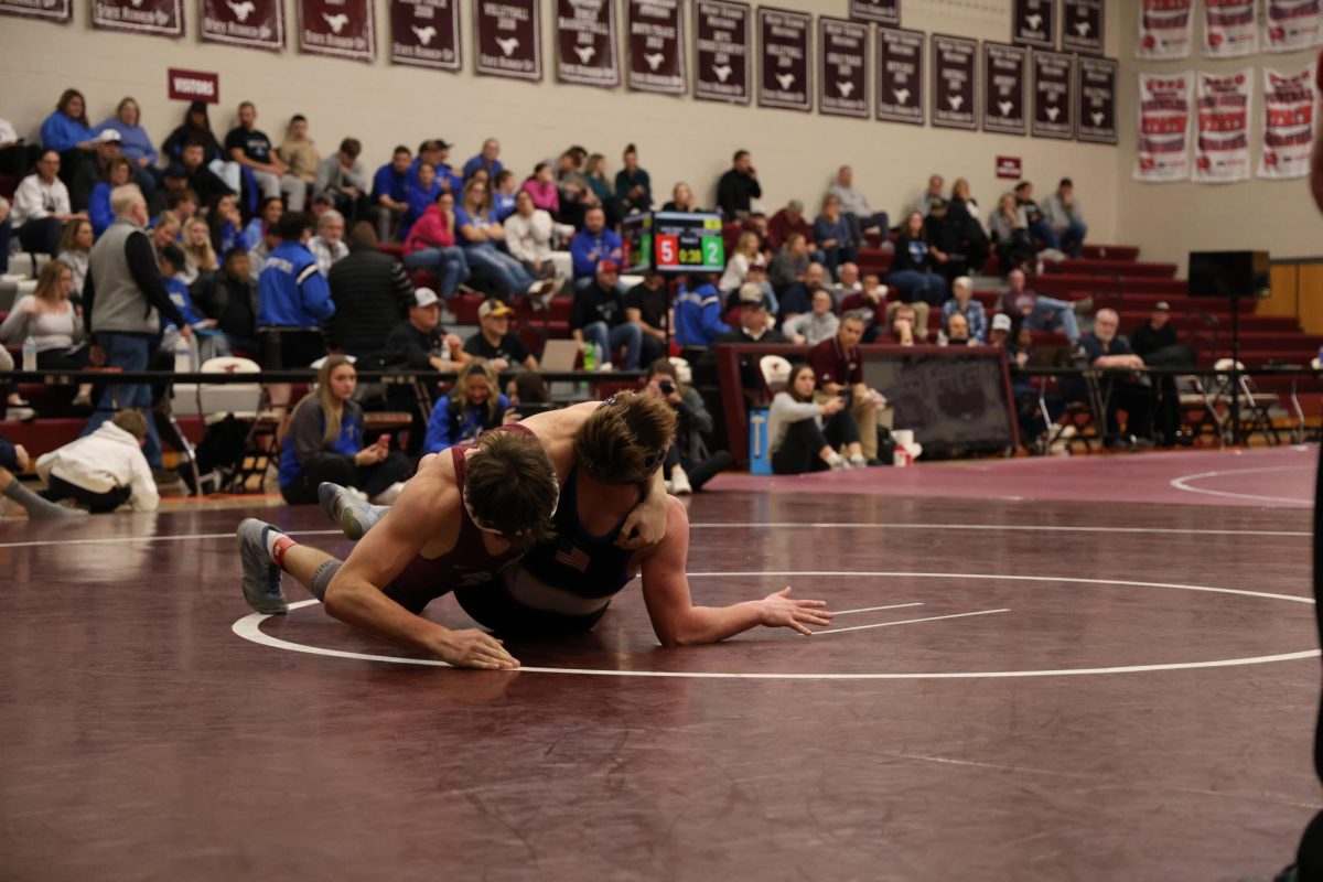 Senior Caleb Keegan wrestling an opponent from Benton High School.