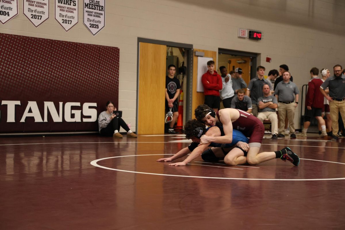 Junior Cooper Krob wrestles his Benton opponent during their varsity tournament on Jan. 8