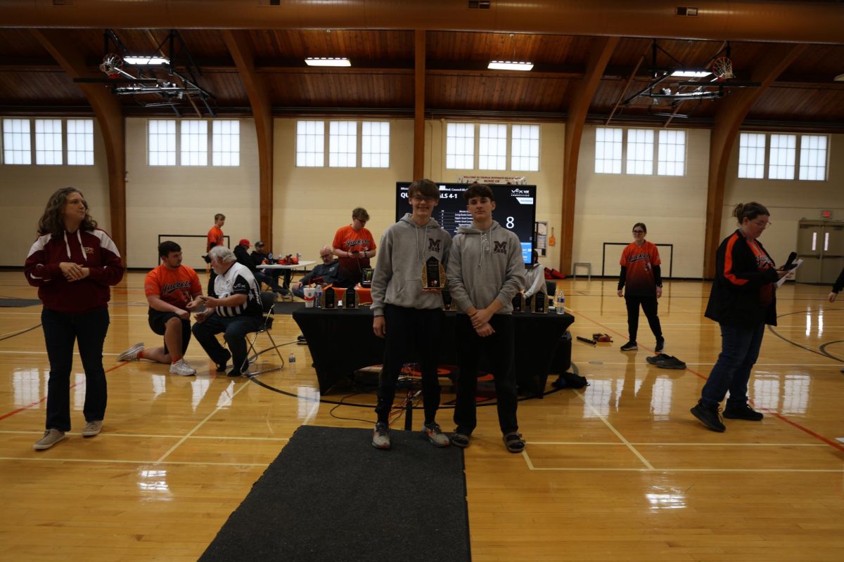 Juniors Matthew Bradbury and Nate Poduska pose for a picture after recieving the Excellence Award for robotics.