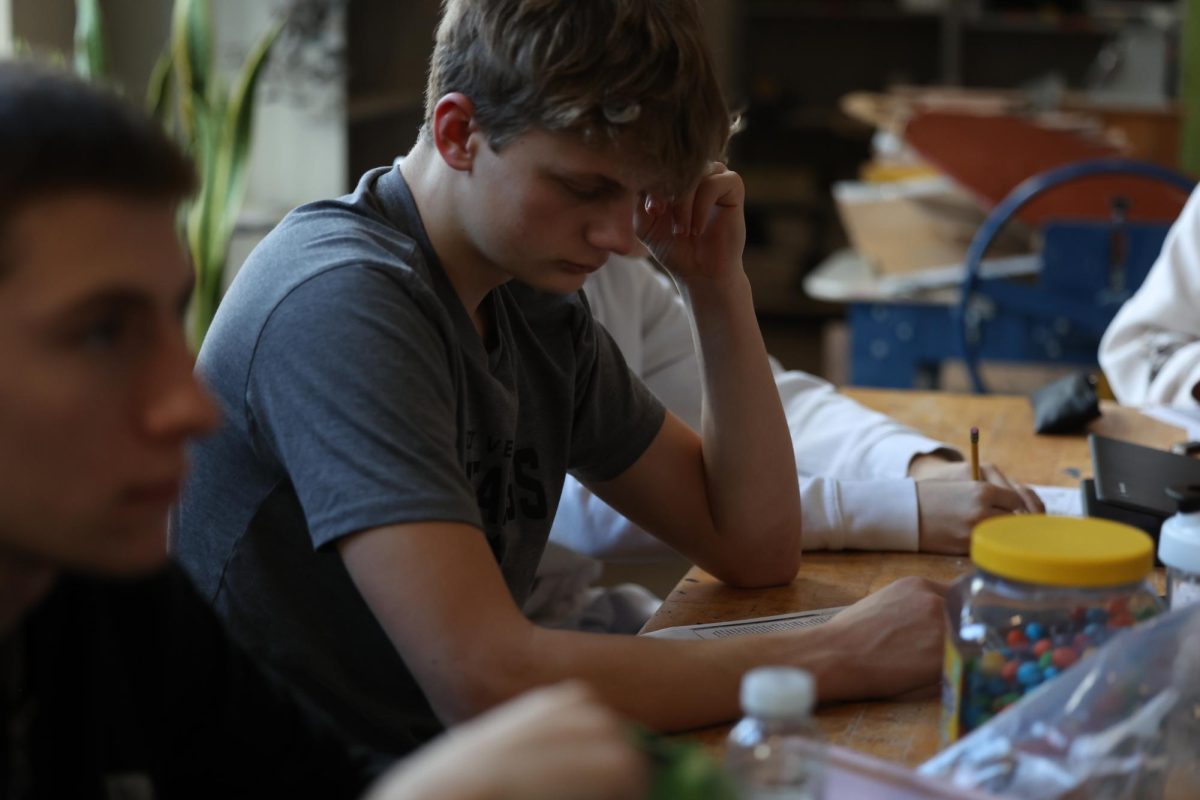 Sophmore Kolter Flockhart examines his paper to create his blackout poetry on Jan. 8. 