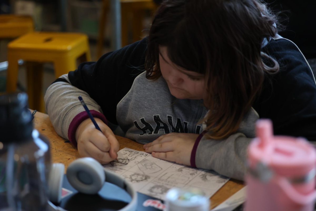 Sophomore Izabella Nelson sketches different scenes of a central character using different shades of pencil to add details on Jan 8 in Creative Collaboration: Art and Poetry taught by Bonnie Ahrens.