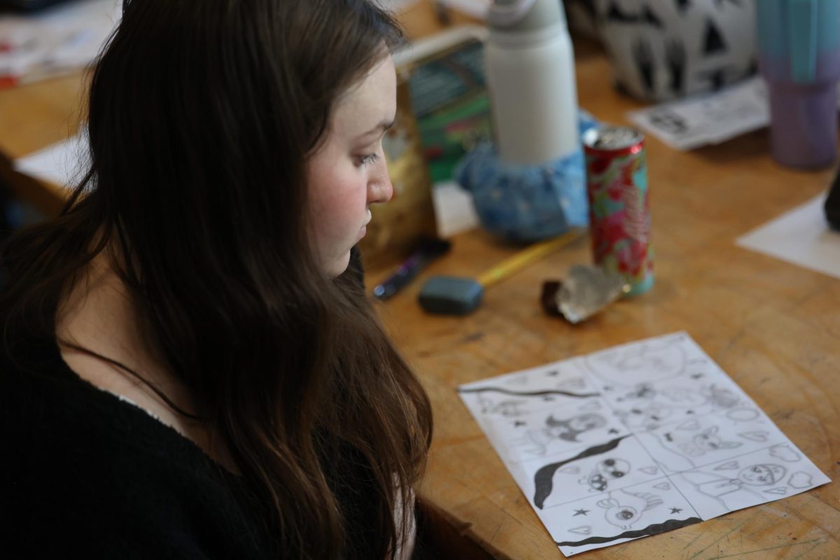 Sophomore Emma Pederson Looks back on her sketch work seeing if it needs improvements Jan. 8.