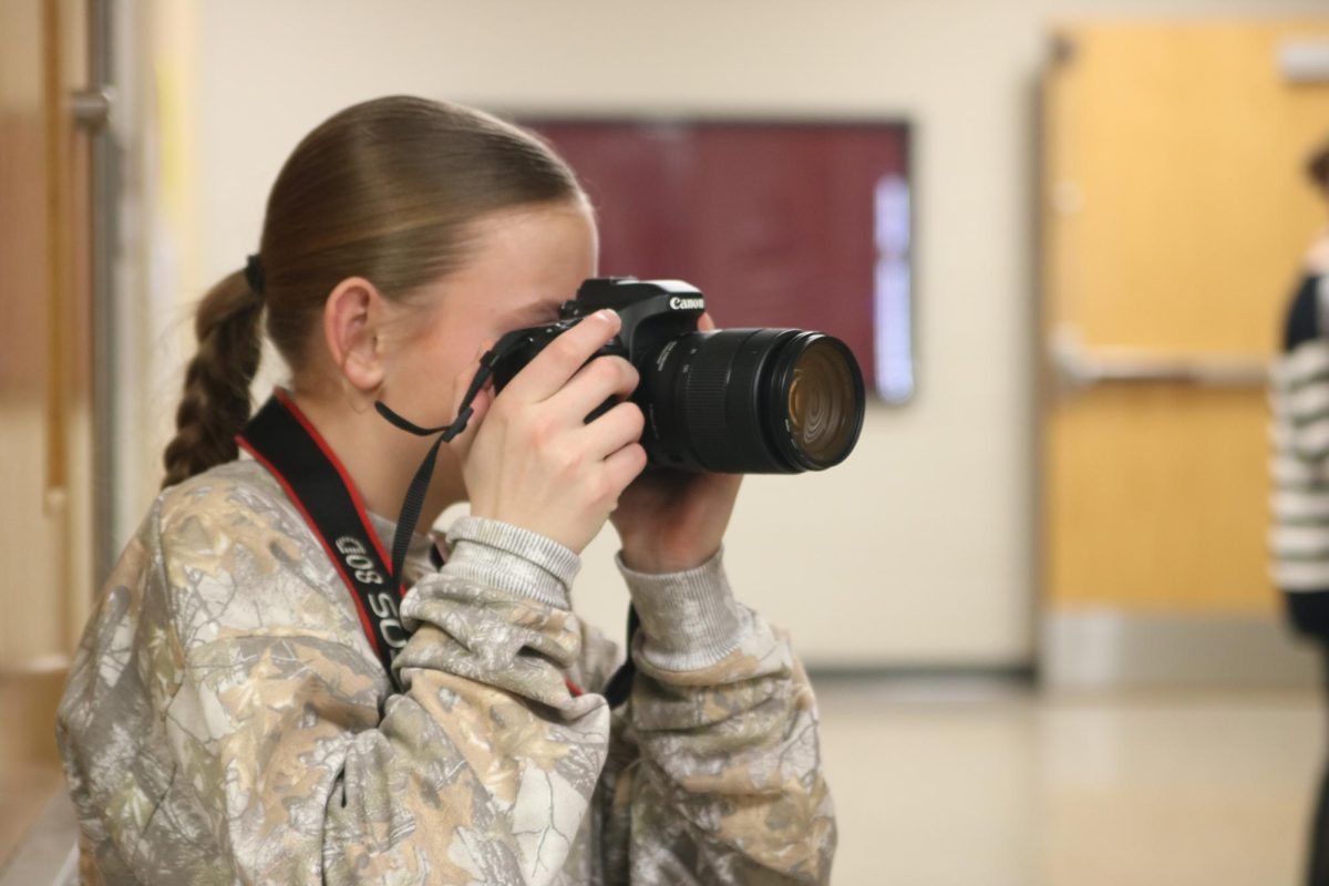 Sophomore Emily Schnoor takes pictures for her Digital Content Creation J-Term class project Jan. 8.
