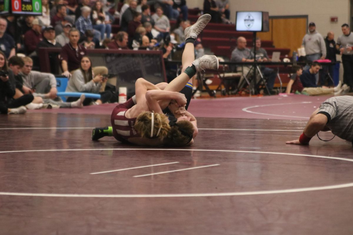 Sophomore Matthew Goodlove wrestles a student from Benton High School.