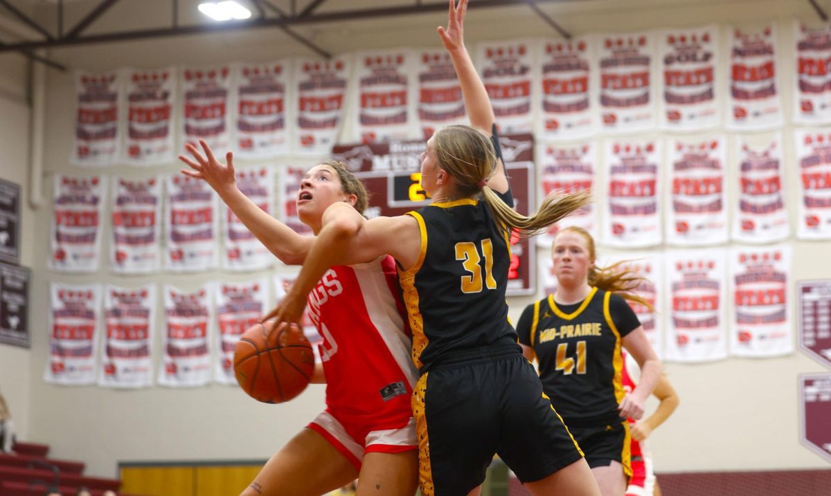 Sophomore Savanna Wright fights her way through Mid-Prairie defense to attempt a shot Dec. 8.