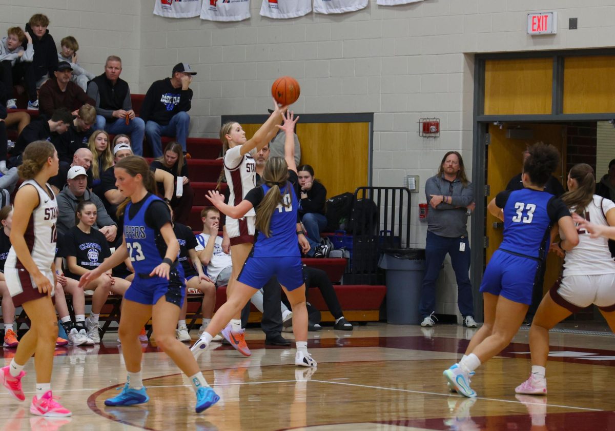 Sophomore Quinn Pershing attempts a 3-point shot Feb. 10 in the win against CCA. Pershing scored 23 points for the Mustangs with a final score of 60-39. 