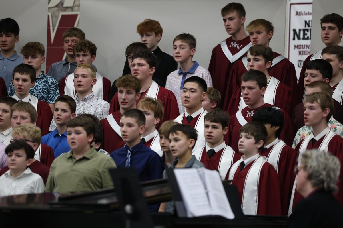 Freshman Quinlan O'Connor performs with the Mixed Choir at the All-Sing concert March 9.