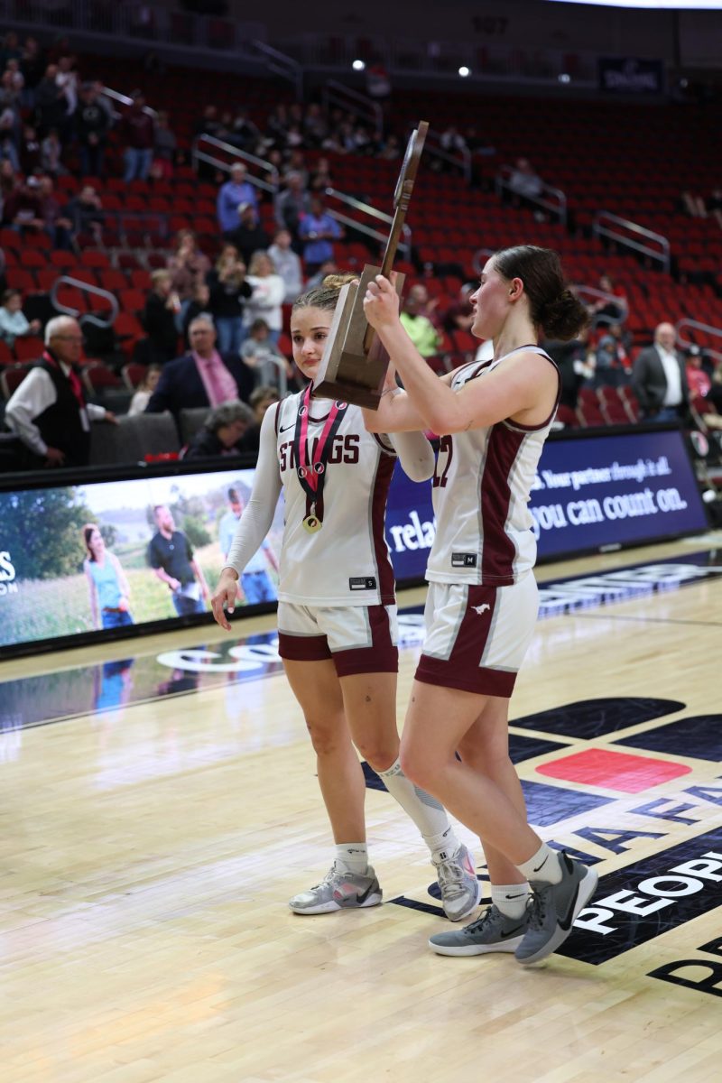 Twins Taylor and Courtney Franck hold the trophy.