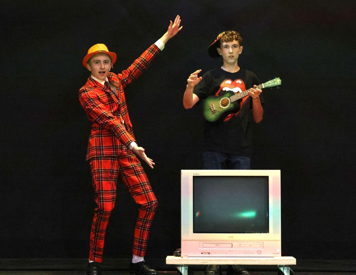 Sophomore Hagen Wilkins and freshman Bryce Pyatt, as Mr. Wormwood and Michael Wormwood, show off their television in the song "Telly".