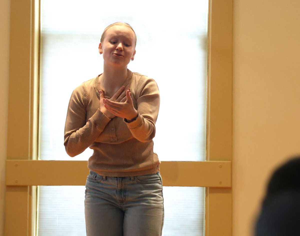 Senior Emma Hoffman looks through college dating profiles during her Acting performance titled "Swipe Right for Stanford".