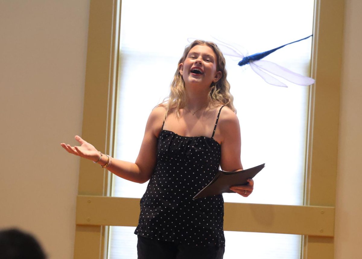 Senior Norah Weber recites her self-written poem "To the Moon and Back" on March 29. 